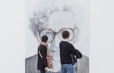 couple looking at painting of old lady